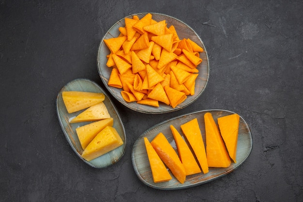 Overhead view of delicious snacks for parties on a dark background