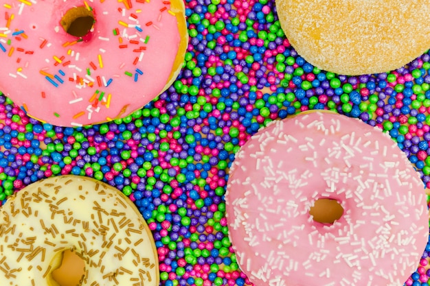 An overhead view of donuts on the sprinkle balls