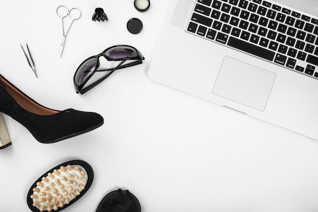 An overhead view of feminine background with laptop