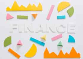 Free photo overhead view of finance word with colorful graph and geometric shape