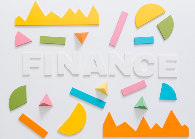 Overhead view of finance word with colorful graph and geometric shape