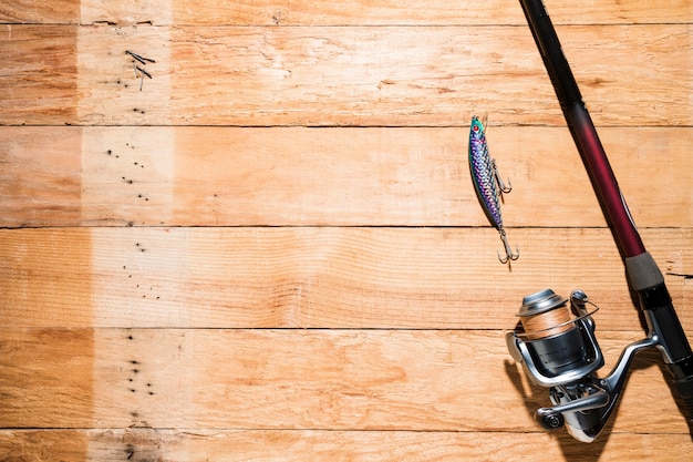 An overhead view of fishing lure with fishing rod on desk