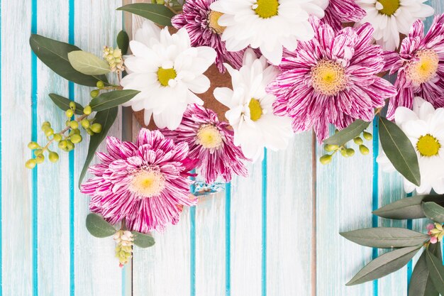 Overhead view of flowers decoration on wooden background