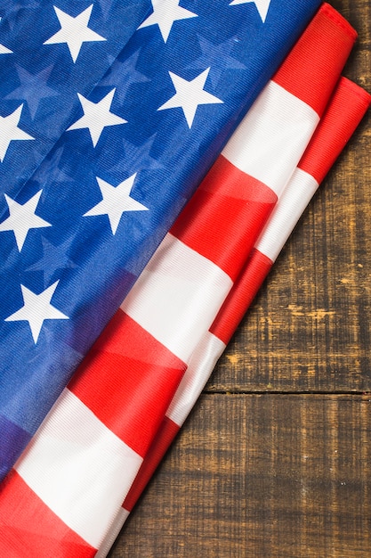 An overhead view of folded american flag on wooden table