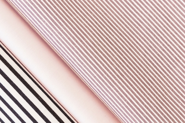 Free photo overhead view of folded black and pink stripes fabric