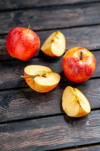 Overhead view of fresh natural chopped and whole red apples on black background