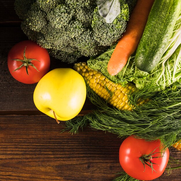 Overhead view of fresh raw vegetables on wooden desk