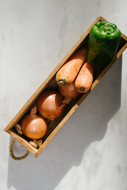 Overhead view of fresh vegetables on marble background