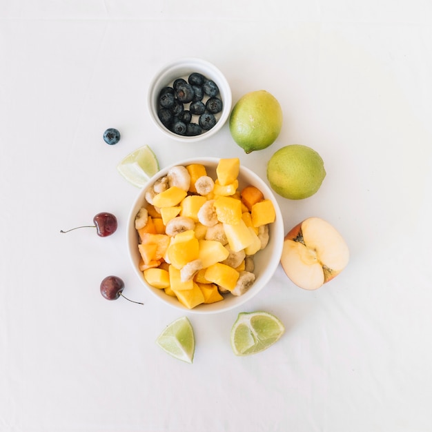 An overhead view of fruit salad bowl on white background