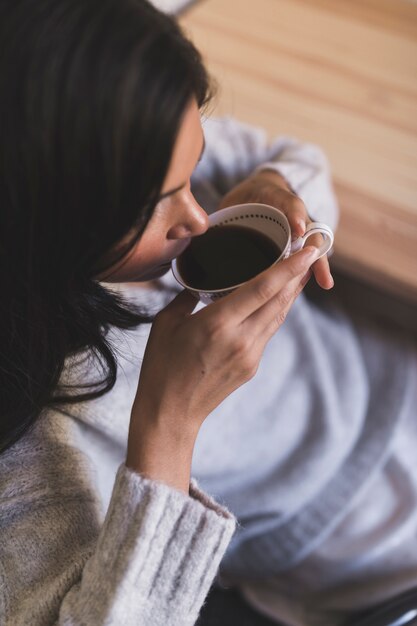 An overhead view of girl drinking coffee