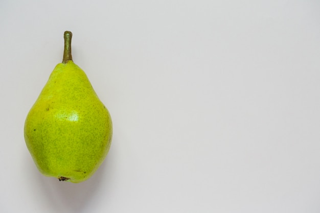 An overhead view of green pear fruit isolated on white background