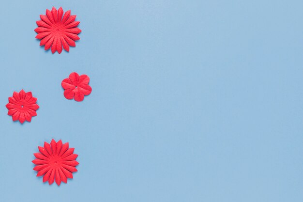 Overhead view of handmade red paper flower cutout for craft