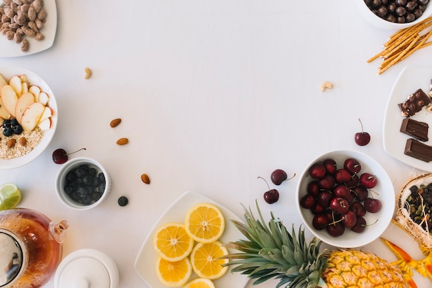 An overhead view of healthy fruits on white background