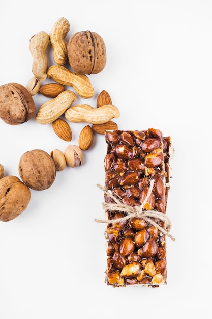 An overhead view of healthy protein bar tied with string on white backdrop