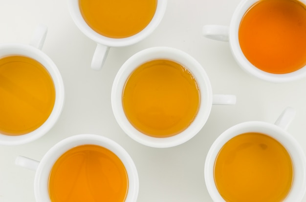 An overhead view of herbal tea cup on white background