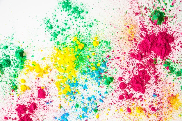 An overhead view of holi powder on white background