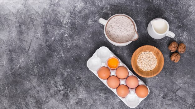 An overhead view of ingredients for making bread on concrete backdrop