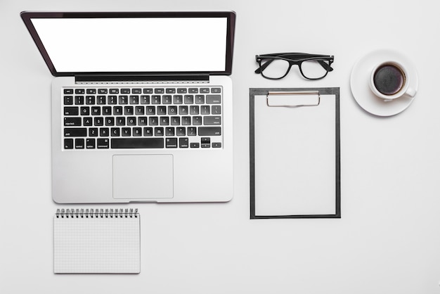 Overhead view of a laptop and coffee cup on office desk