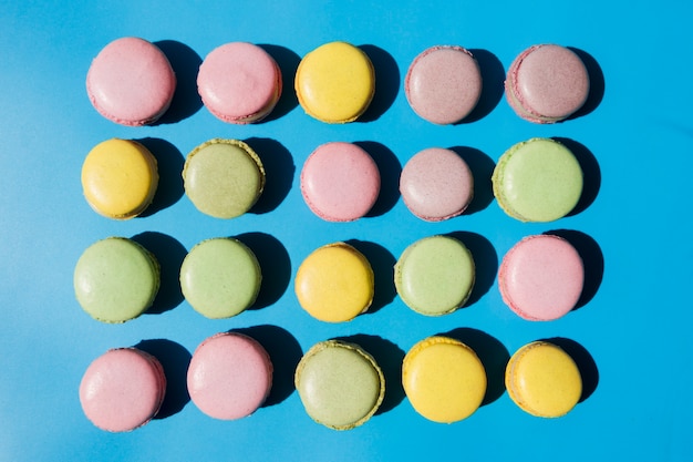 An overhead view of macaroons on blue background