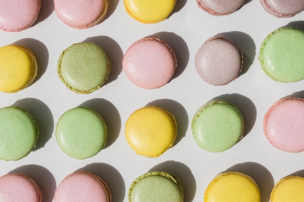 An overhead view of macaroons on white backdrop