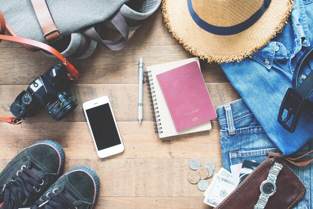 Overhead view of man's accessories, Traveler items on wooden background. Travel concept