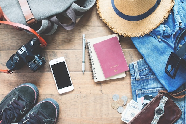 Overhead view of man's accessories, Traveler items on wooden background. Travel concept