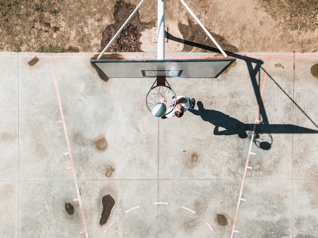 Overhead view of man throwing ball in the basketball