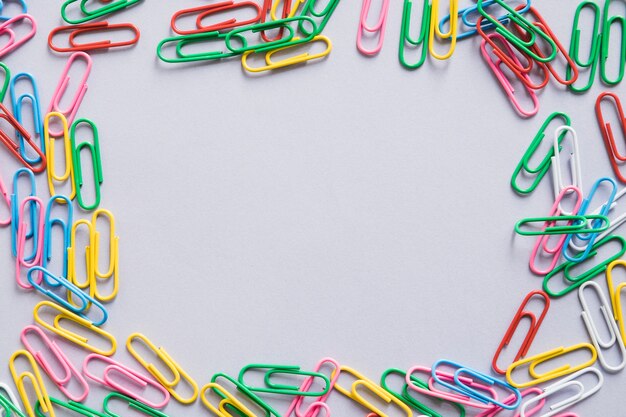 Overhead view of many colorful paper clips forming frame