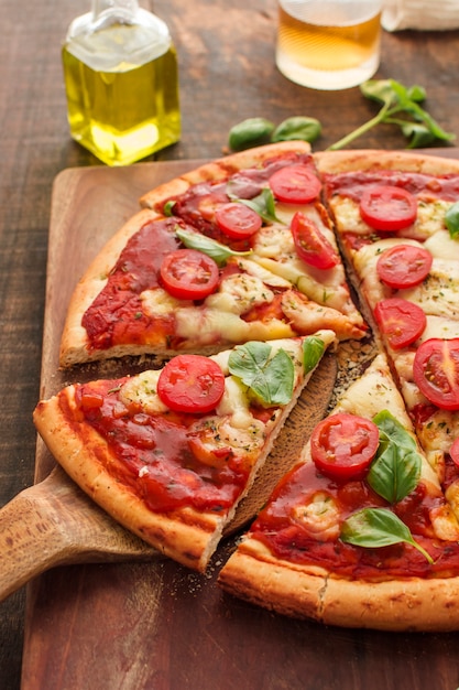 An overhead view of margherita pizza on chopping board