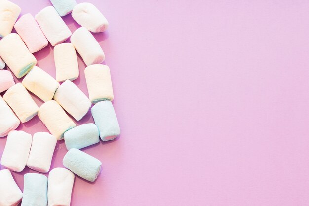 Overhead view of marshmallows on pink backdrop