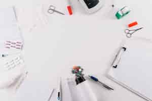 Free photo an overhead view of medical equipments and pills isolated on white backdrop