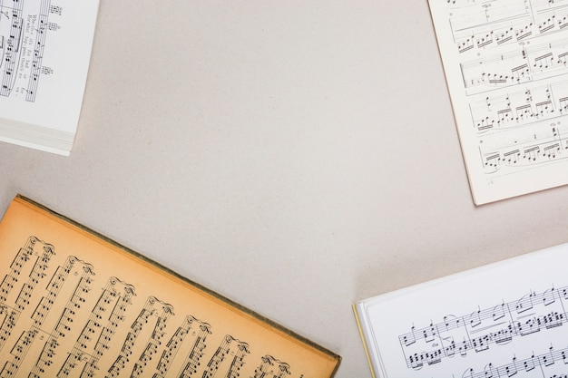 An overhead view of musical note books on white background with space for text