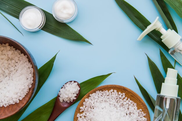 An overhead view of natural bodycare cosmetics product on blue background