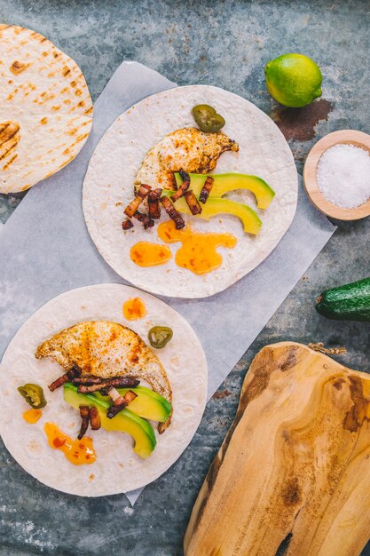 Overhead view of omelet with avocado on tortilla