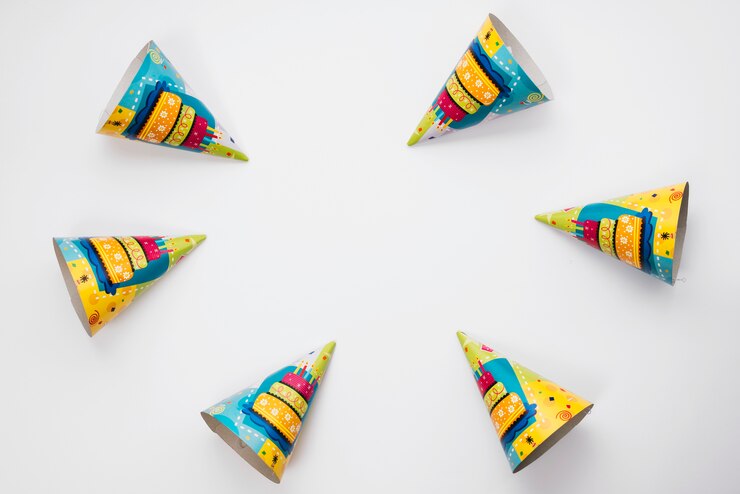 Free Photo an overhead view of party hats arranged on white background