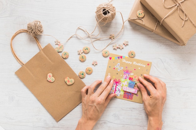 An overhead view of a person making birthday greeting card