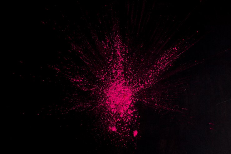 Free Photo overhead view of pink color exploding on black surface