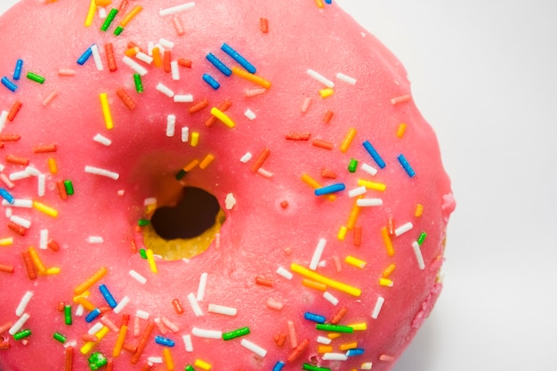 An overhead view of pink donuts with sprinkles