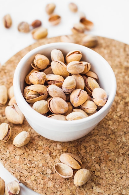 An overhead view of pistachio shells on cork coaster