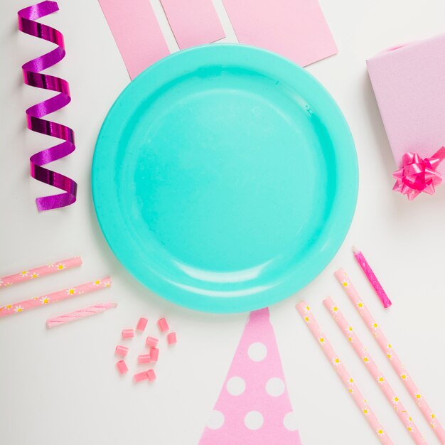 Overhead view of plate surrounded with decorative items on white backdrop