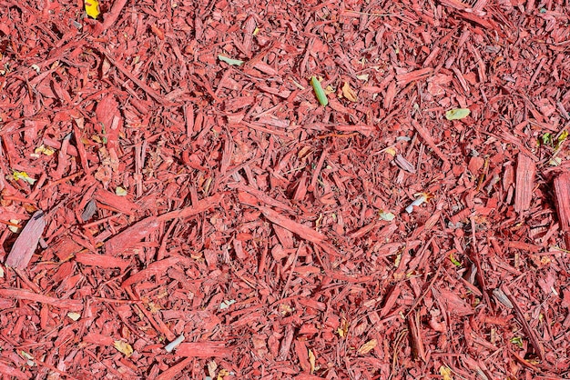 Overhead view of red mulch used to decorate and protect a garden or park urban environment and ecosystem decoration urban space design