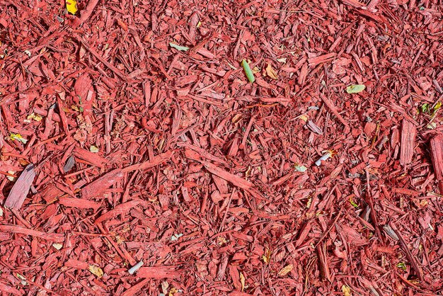 Overhead view of red mulch used to decorate and protect a garden or park urban environment and ecosystem decoration urban space design