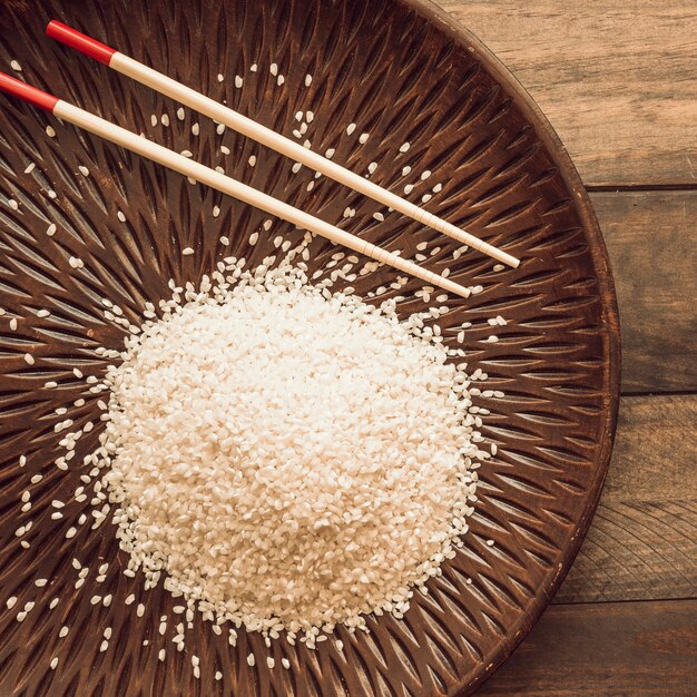 Overhead view of rice grains with chopstick