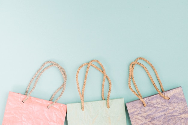 Free photo overhead view of shopping bags at the bottom of green background