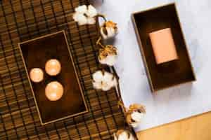 Free photo overhead view of soap and cotton flower over the desk