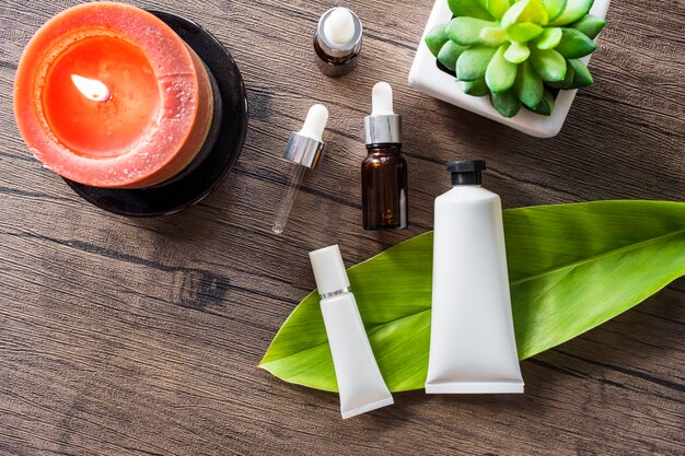 Overhead view of spa cosmetic product and essential oil on wooden table