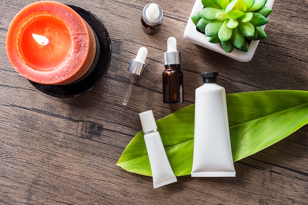 Overhead view of spa cosmetic product and essential oil on wooden table