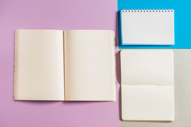 Overhead view of spiral books on multicolored background