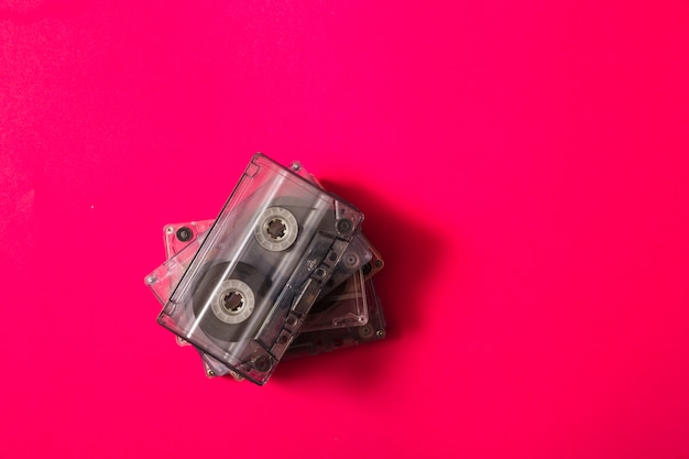 An overhead view of stack cassette tapes on red background