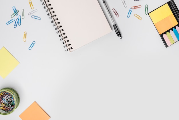 An overhead view of stationeries on white background